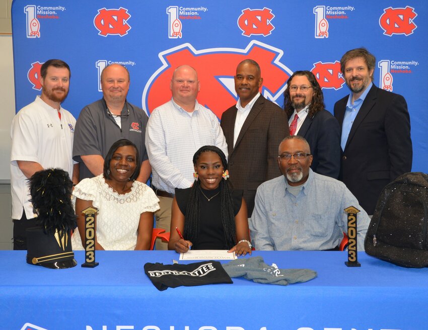 Neshoba Central’s Nicole Moore signed with East Central Community College to further her education, be a member of the Centralettes and the Wall O’ Sound Band. Pictured, from left, are her mother Charlotte Moore, Nicole Moore and her father David Moore. (Back) Asst. Principal Jonathan Walker, Principal Jason Gentry, Asst. Principal Brent Pouncy Asst. Principal LaShon Horne, Band Director Daniel Wade,  and ECCC Representative Justin Sharp.